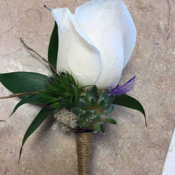 White calla lily boutonniere with succulent and green accents