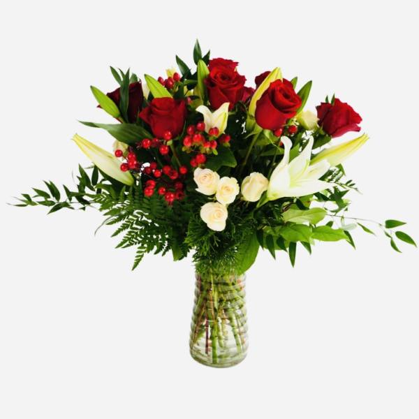 Red roses and white lilies in a clear glass vase
