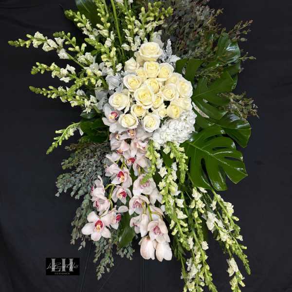 Tall floral spray with white roses, orchids, and snapdragons