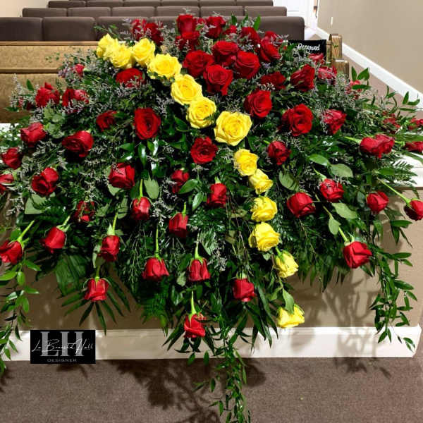 Large casket spray of red and yellow roses