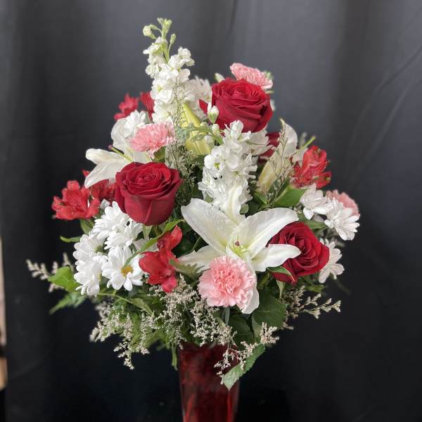 Red roses and white lilies in a red vase