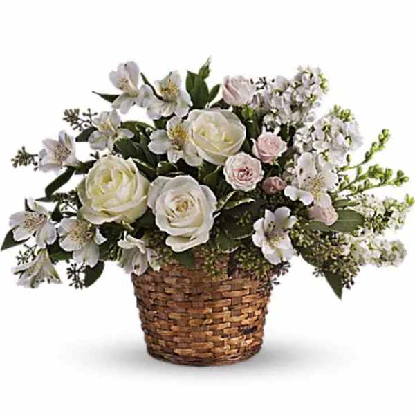 White and pale pink flowers arranged in a woven basket