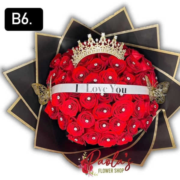 Heart-shaped bouquet of red roses with a crown and ribbon