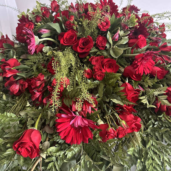 Large red floral spray with roses and gerbera daisies