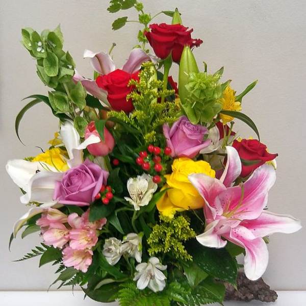 Mixed bouquet of roses and lilies in a glass vase