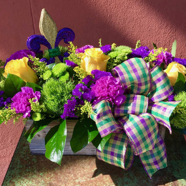 Yellow roses and purple flowers in a wooden box with a plaid ribbon