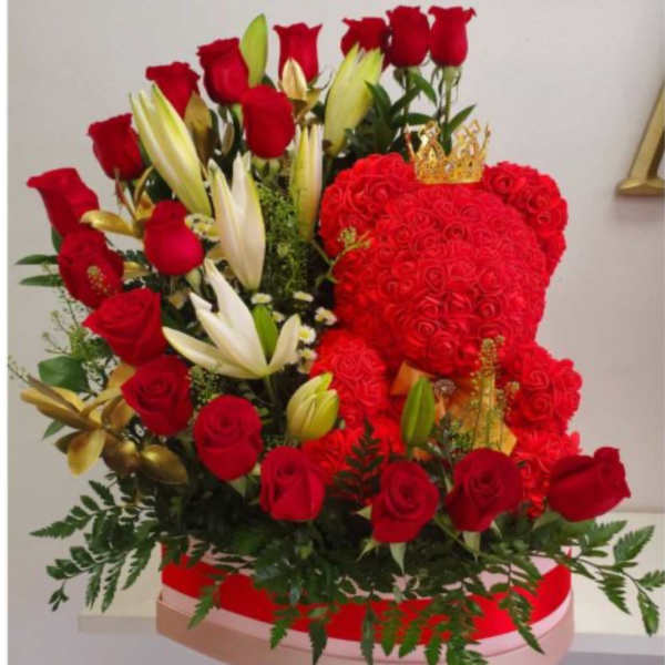 Red roses and white lilies arranged in a heart-shaped box with a small crown