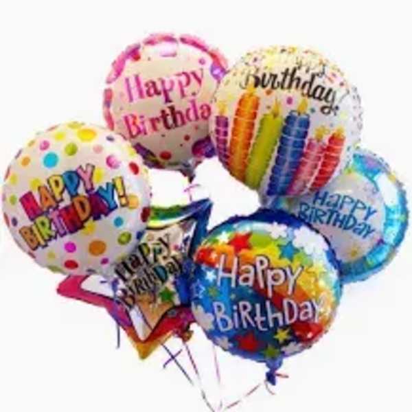 Cluster of colorful birthday balloons with printed messages