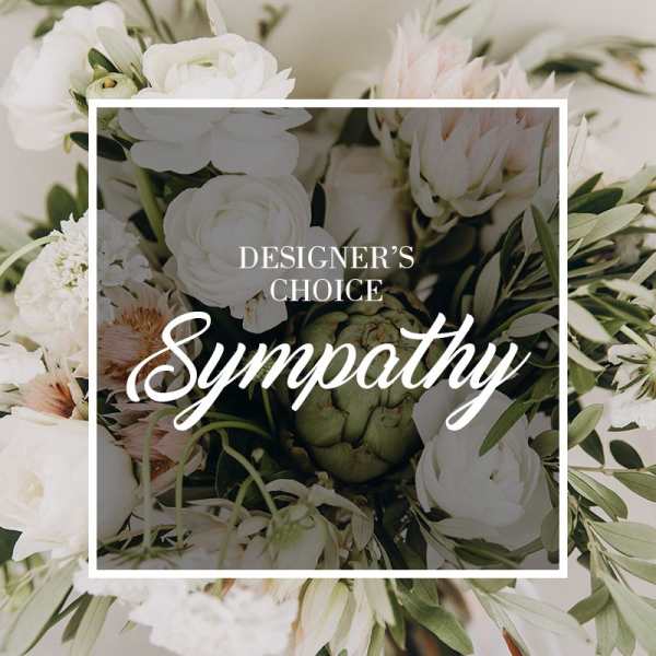White sympathy floral arrangement with mixed blooms and greenery