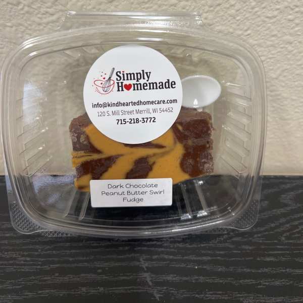 Plastic clamshell container holding dark chocolate peanut butter swirl fudge