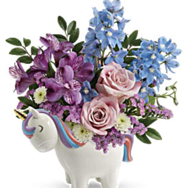Pink and blue flowers arranged in a unicorn-shaped vase