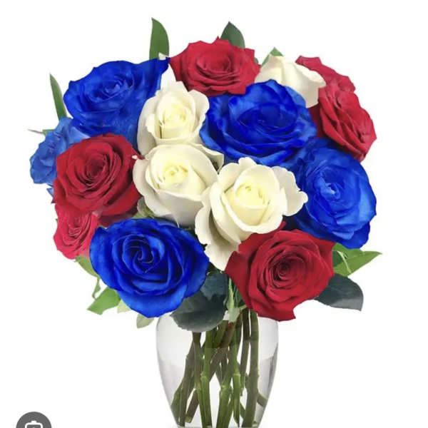 Bouquet of red, white, and blue roses in a clear glass vase