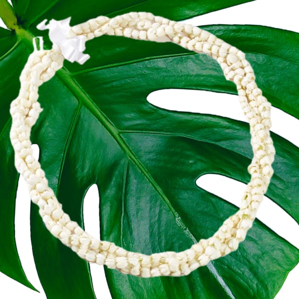 White flower lei on a large green leaf