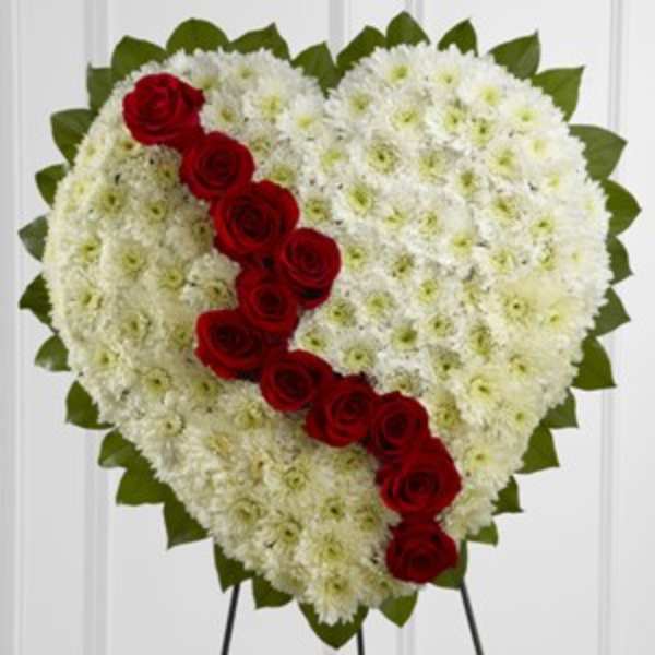Heart-shaped white floral spray with a diagonal line of red roses
