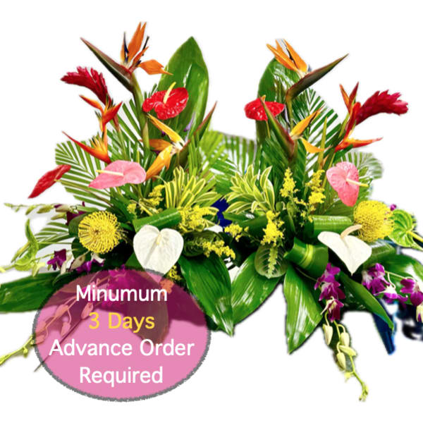 Tropical floral arrangement with red, pink, yellow, and white blooms