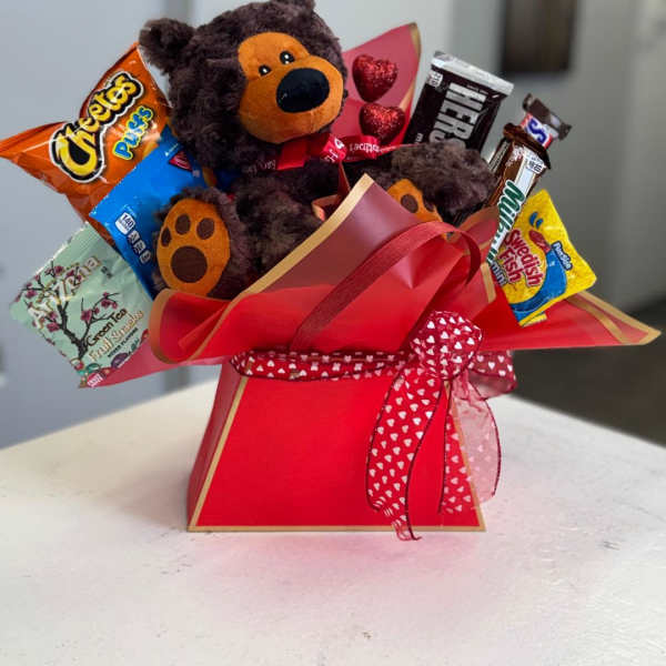 Teddy bear gift arrangement with assorted candy in a red box