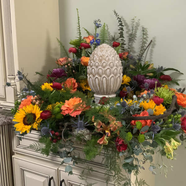 Colorful floral arrangement with a decorative white egg centerpiece