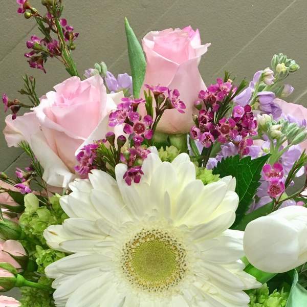 Bouquet of pink roses, white gerbera daisies, and purple filler flowers