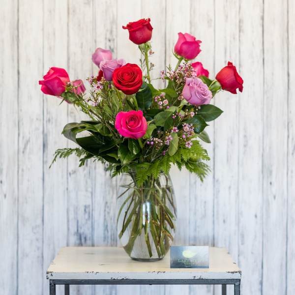 Pink and red roses in a clear glass vase