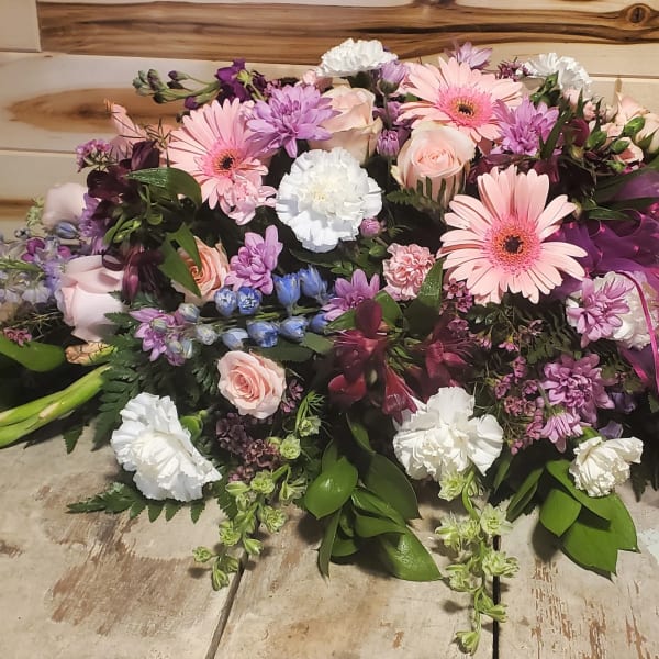 Large pastel bouquet with pink gerberas, roses, and purple flowers
