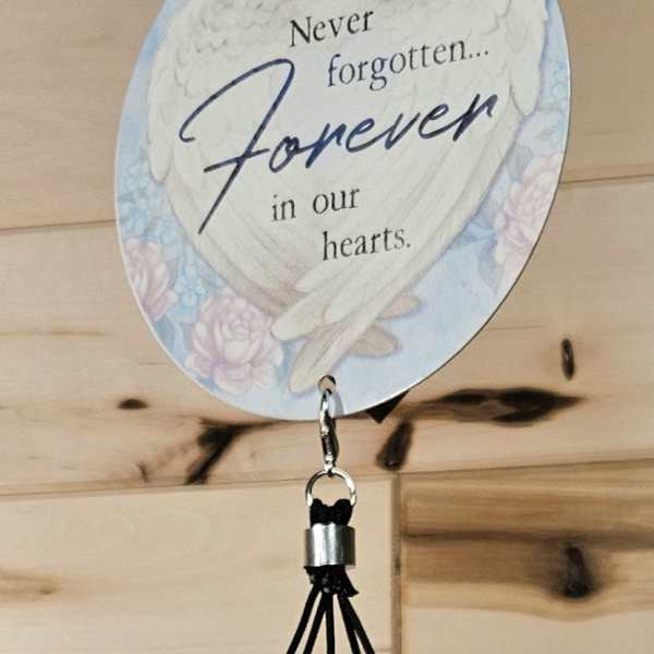 Memorial wind chime with a heart-shaped plaque and metal tubes