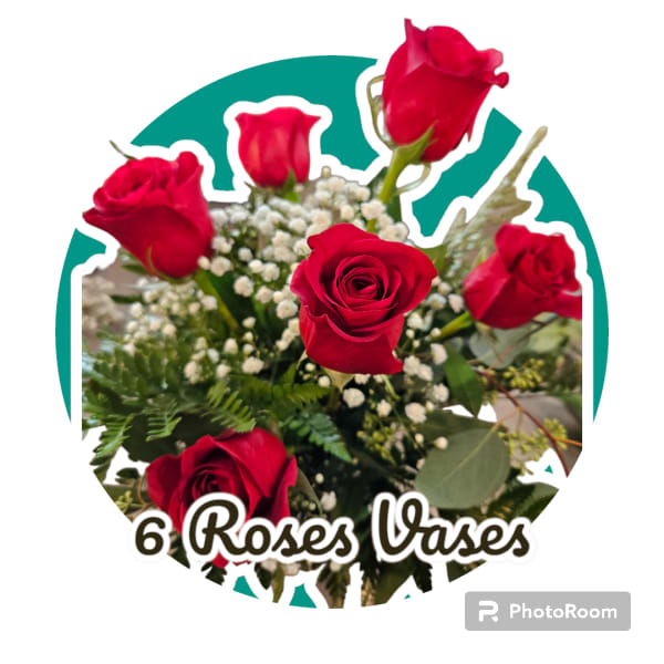 Six red roses with baby's breath and greenery