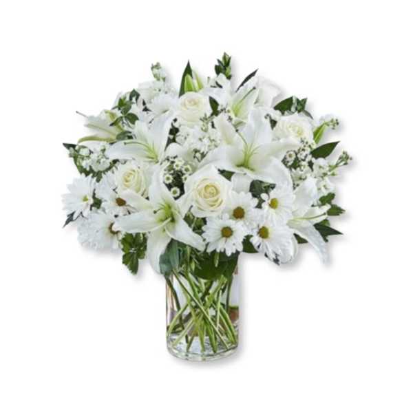 White lilies, roses, and daisies arranged in a clear glass vase
