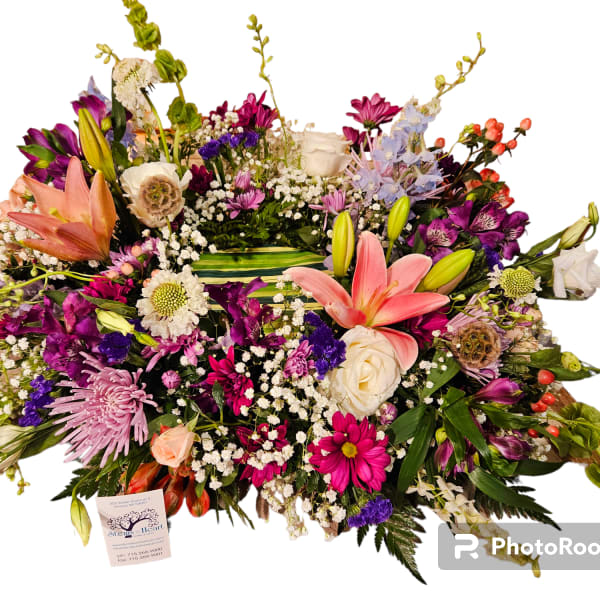 Large mixed flower arrangement with lilies, roses, and daisies