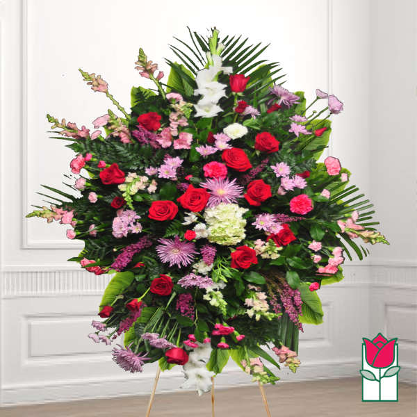 Large standing floral spray with red roses, pink blooms, and white flowers