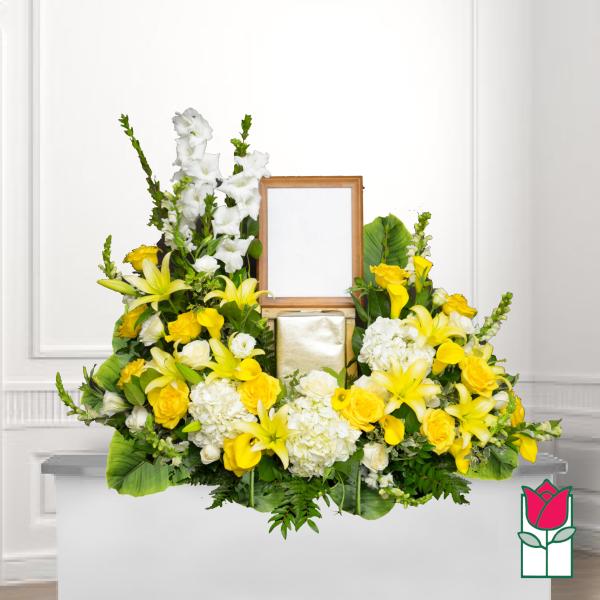 Yellow and white floral funeral tribute with a framed photo holder