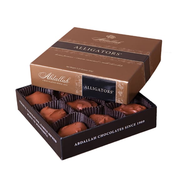 Open box of assorted milk chocolates in brown Abdallah Alligators packaging