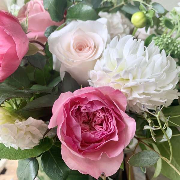 Pink and white roses with white chrysanthemum blooms in a bouquet