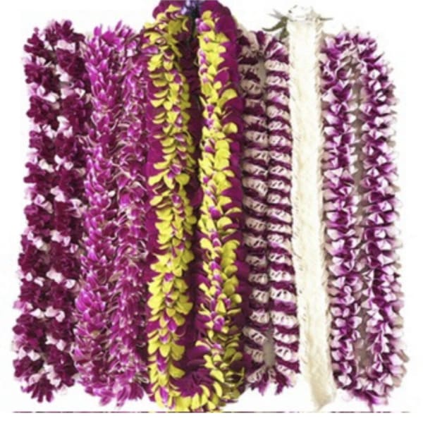 Several purple and yellow flower leis arranged side by side.