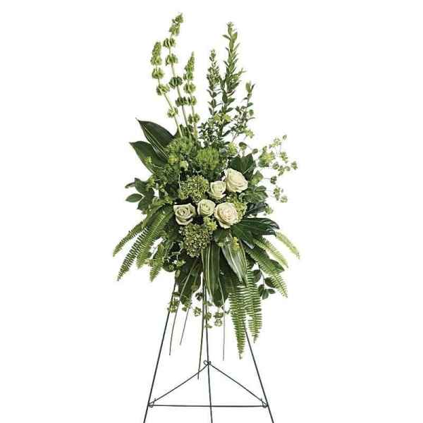 Tall white rose and greenery standing spray on an easel