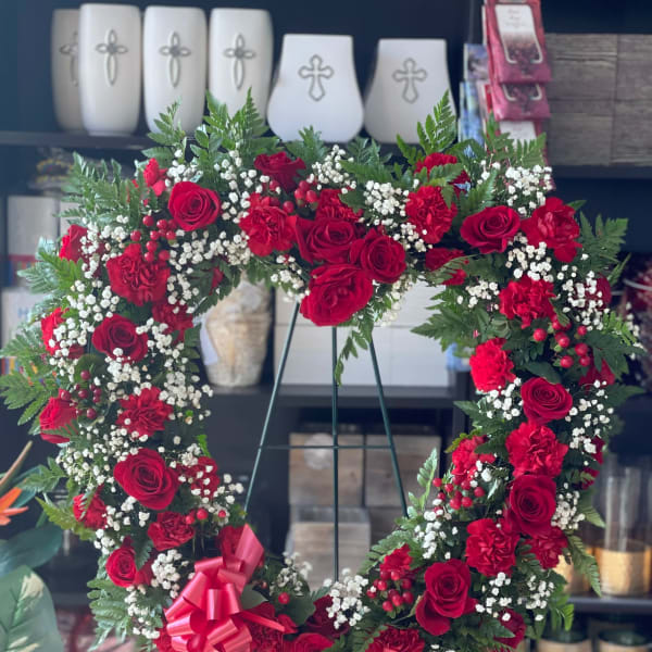 Heart-shaped floral wreath with red roses and carnations