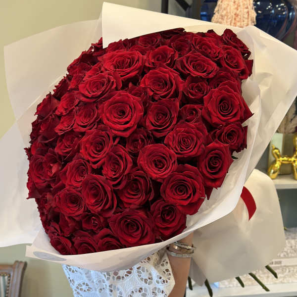 Large bouquet of red roses wrapped in white paper