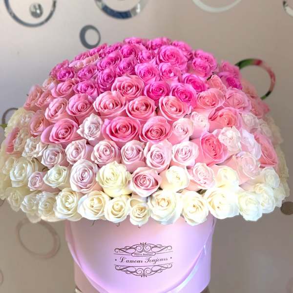 Large bouquet of pink and white roses in a pink hat box