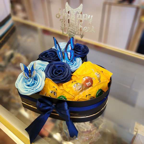 Gift box with satin roses, butterflies, and candy bars