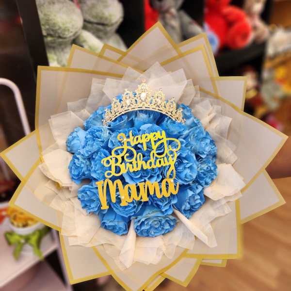 Blue rose bouquet with a gold birthday topper and crown
