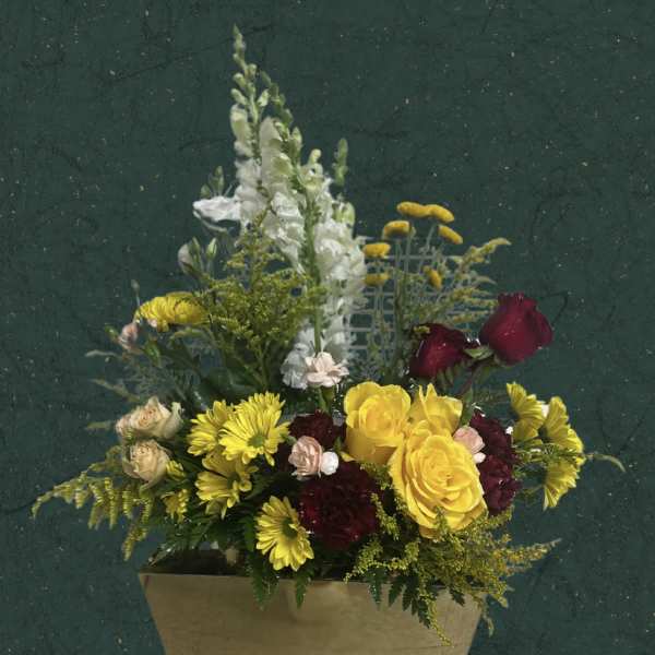 Mixed bouquet in a beige cone wrap with yellow and red flowers