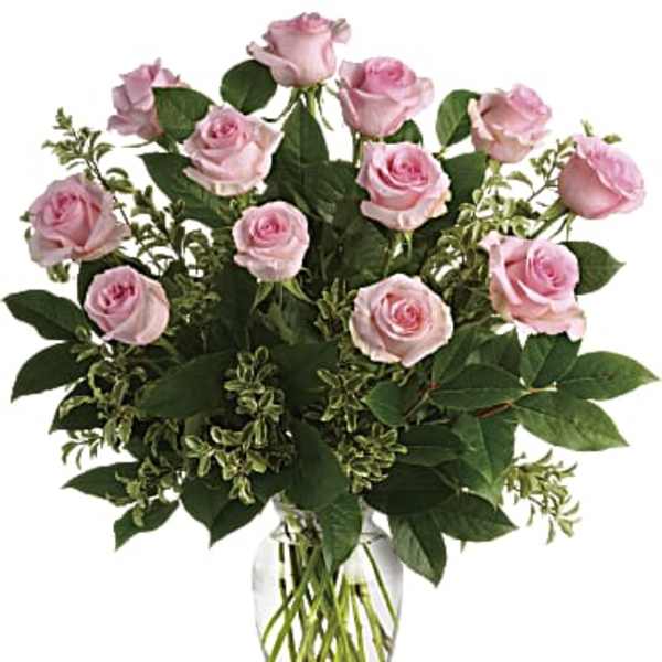 Pink roses arranged in a clear glass vase