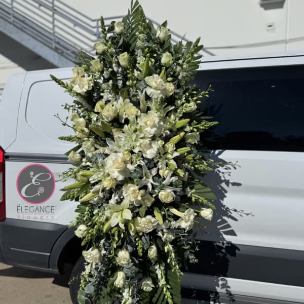 Tall white floral standing spray with lilies and roses