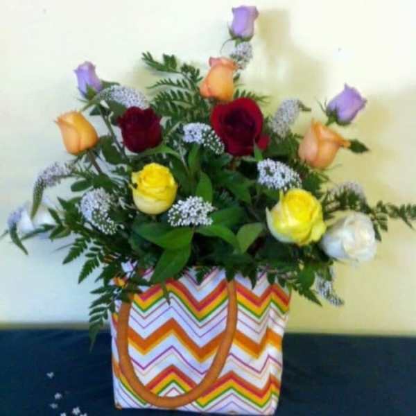 Mixed roses in a chevron-patterned tote bag