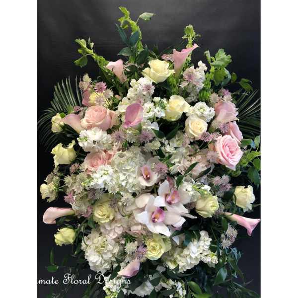 Large pastel floral spray with roses, calla lilies, hydrangeas, and orchids