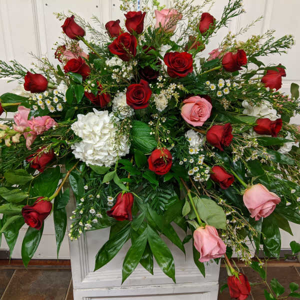 Large floral spray with red and pink roses and white blooms
