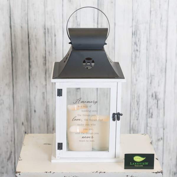 White lantern with candles and a memory quote