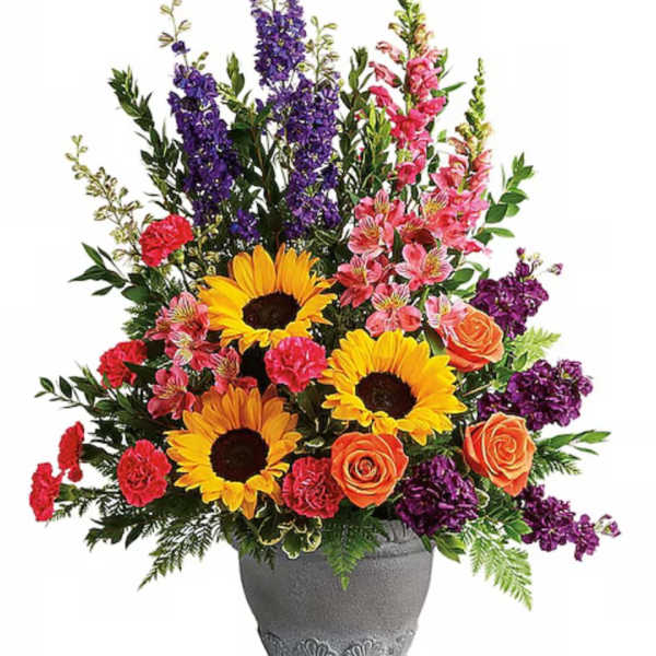 Colorful mixed flower arrangement in a gray vase with sunflowers and roses