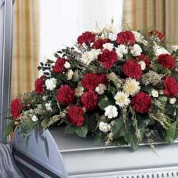 Red and white floral casket spray with greenery