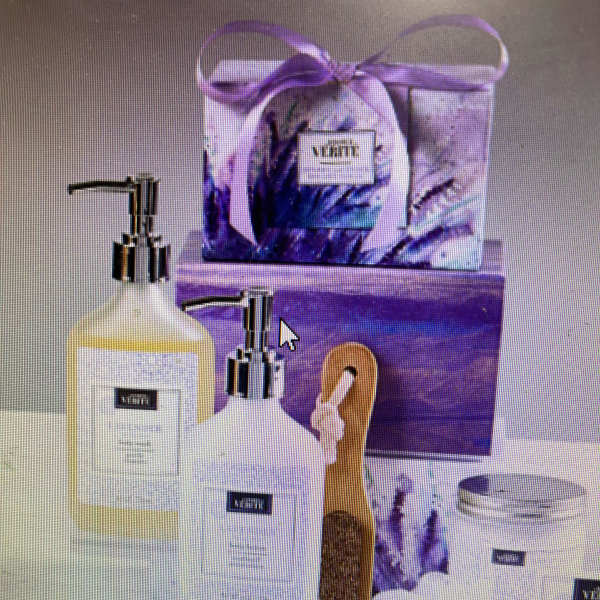 Purple bath gift set with soap dispensers, brush, and wrapped package