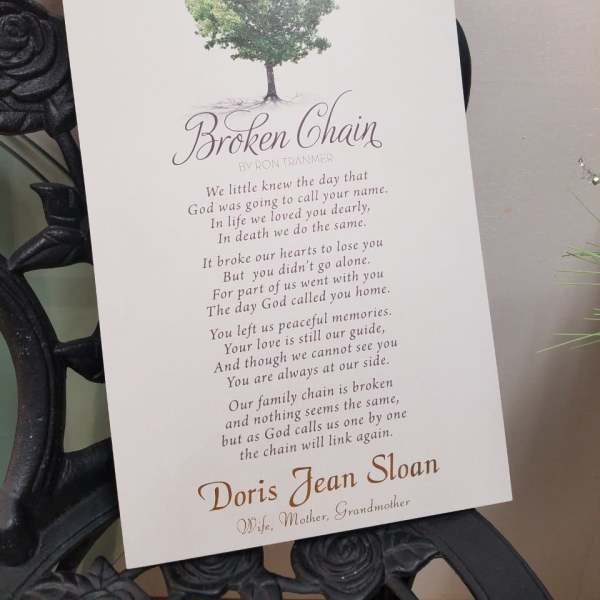 Memorial card with a tree graphic and poem on a white card